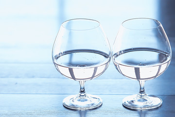 glass of white wine in the restaurant / white wine in the interior of the restaurant a table with glasses of wine, a romantic summer