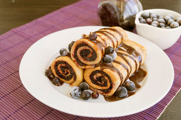 Homemade pancakes rolled with fresh berry jam.