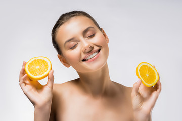 young smiling woman with closed eyes and orange slices