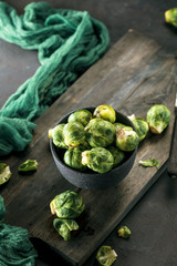 Fresh raw brussels sprouts on a wooden table