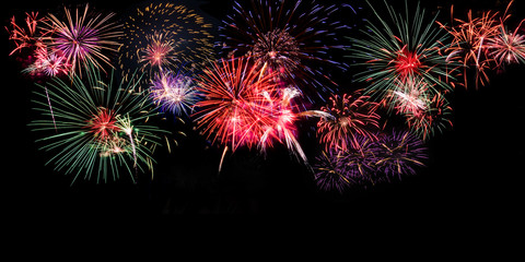 Fototapeta premium Colourful Fireworks on black background with copy space at the bottom for text insertion or decoration, holiday celebration concept