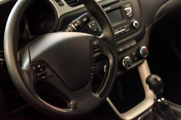 Steering wheel of modern car close up