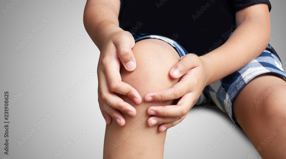 Wall mural asian kid with knee pain, isolated background