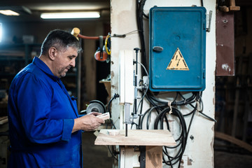 employee drills the item in the workshop with the help of a drilling press