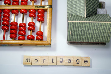 abacus, mini house and mortgage word tiles