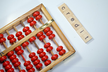 Old abacus and credit word tiles