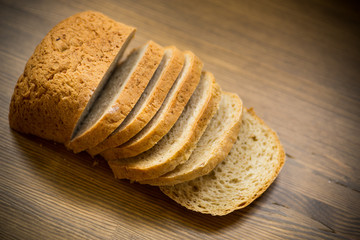 fresh homemade bread sliced on wooden background
