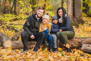 Fototapeta premium A Happy family resting in beautiful autumn park