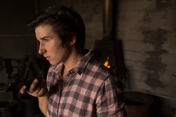 Metalsmith talking on mobile phone