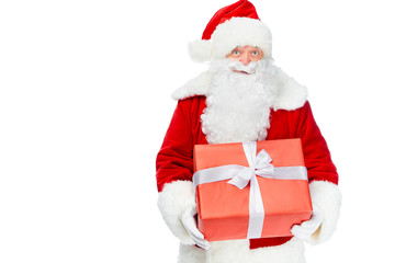 santa claus holding red christmas gift isolated on white