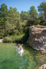 jumping in natural pool 