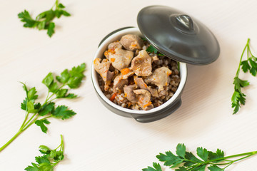 stewed chicken stomachs with vegetables and buckwheat in a bowl