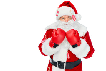 serious santa claus in boxing gloves and red costume with sale tags isolated on white