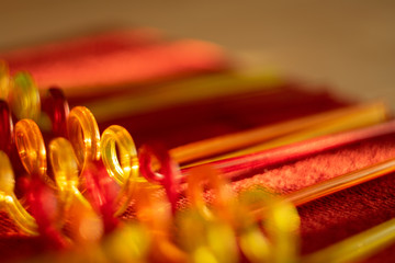 Color tubes for drinking juices. Curved in the form of a spiral. Blurred bright background...