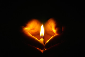 The hand that protects the candles in the dark