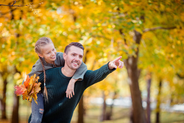 Family of dad and kid on beautiful autumn day in the park