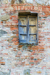 Old weathered window on a brick wall