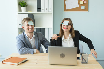 Business, break and people concept - Cheerful man and woman playing games in office while working
