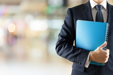 Portrait of happy businessman on background