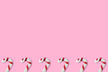 Christmas candies cane pattern on pink background, for New Year and Christmas background.