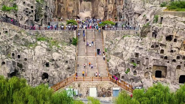 Visitors climbing upstairs to reach Fengxiangsi Cave. Finest buddhist art in Louyang, China