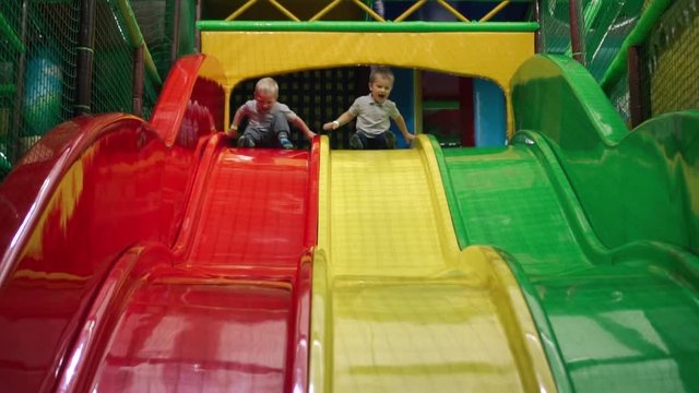 Kids riding from childrens slides in the entertainment center