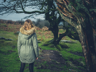 Woman standing by tree on the moor