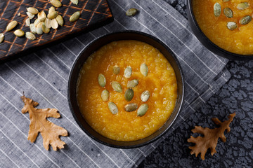 Tasty pumpkin soup. Autumn still life on a dark background.