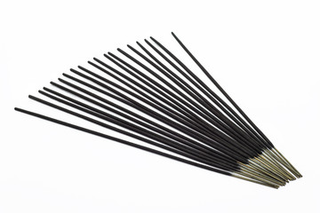 A stick of fragrant, Asian incense isolated on a white background with a clipping path.