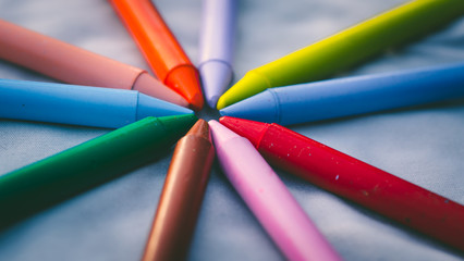 Fototapeta premium Crayon tips close-up. Shallow depth of field for dreamy impressional feel. Rainbow crayons