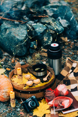 Autumn picnic by the fire in nature: coffee pot, waffles, fire, stylishly served in the style of hugge.