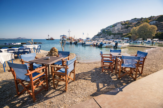 Tables and chairs near harbor in Kolymbia (Rhodes, Greece)