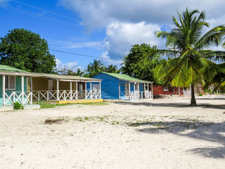 La Romana, Dominican Republic - December 28, 2014:  houses on the beach  of a small village  of a typical tropical island of the caribbean