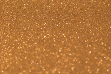 Sparkle glittering background. Glitter vintage lights background. Gold. De-focused. Abstract bokeh lights.