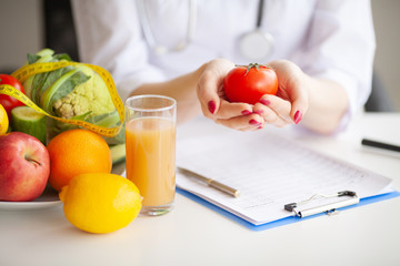 Conceptual Photo Of A Female Nutritionist With Fruits On The Desk
