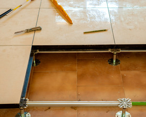 Worker who creates a floating raised floor. Selective focus