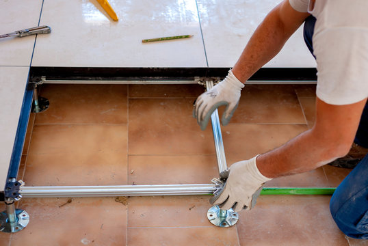 Worker who creates a floating raised floor. Selective focus