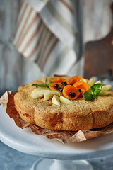 apple pie with apricot pieces on a white support