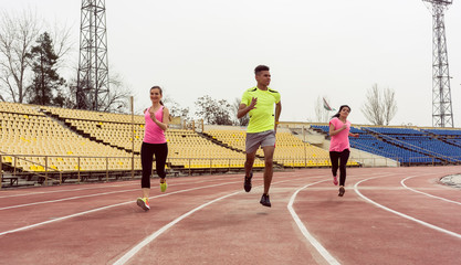 Young runner running on sport ground