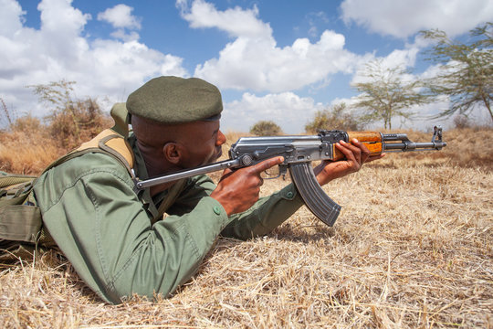 Soldier aiming machine gun