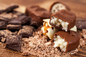 Various yummy chocolate candies on wooden table, sweets