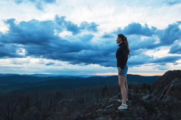 Travel, lesure and freedom concept - woman on the top of Altai mountain, beauty summer evening landcape