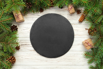 top view. Empty black slate plate on wooden christmas background. holiday dinner dish concept with...