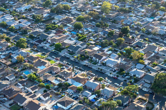 Late afternoon aerial view older San Fernando Valley residential streets and homes near Van Nuys in Los Angeles, California.