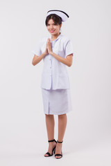 friendly smiling female nurse with Asian Thai style welcoming gesture