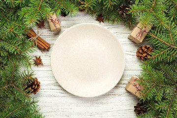 top view. Empty plate round ceramic on wooden christmas background. holiday dinner dish concept with new year decor