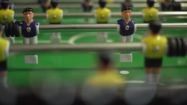 Closeup of playing table football between yellow and blue teams, Foosball
It's also a sport, and one that is played on every continent. The faster your shot is the better chance