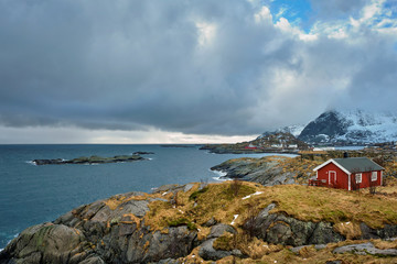 Clif with traditional red rorbu house on Lofoten Islands, Norway