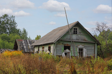 Old broken log wooden house in Russian village