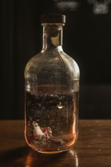 Santa Claus is sitting at the bottom of the bottle